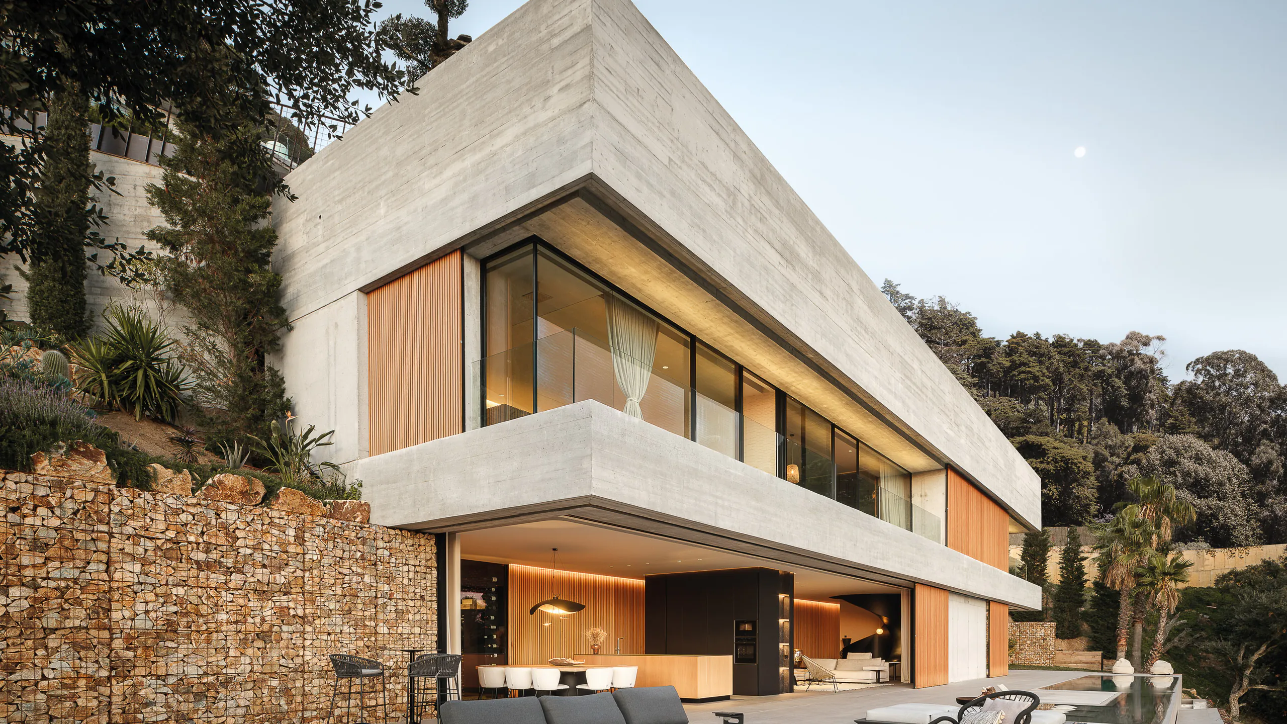 Hillside residence combining concrete timber and panoramic glazing