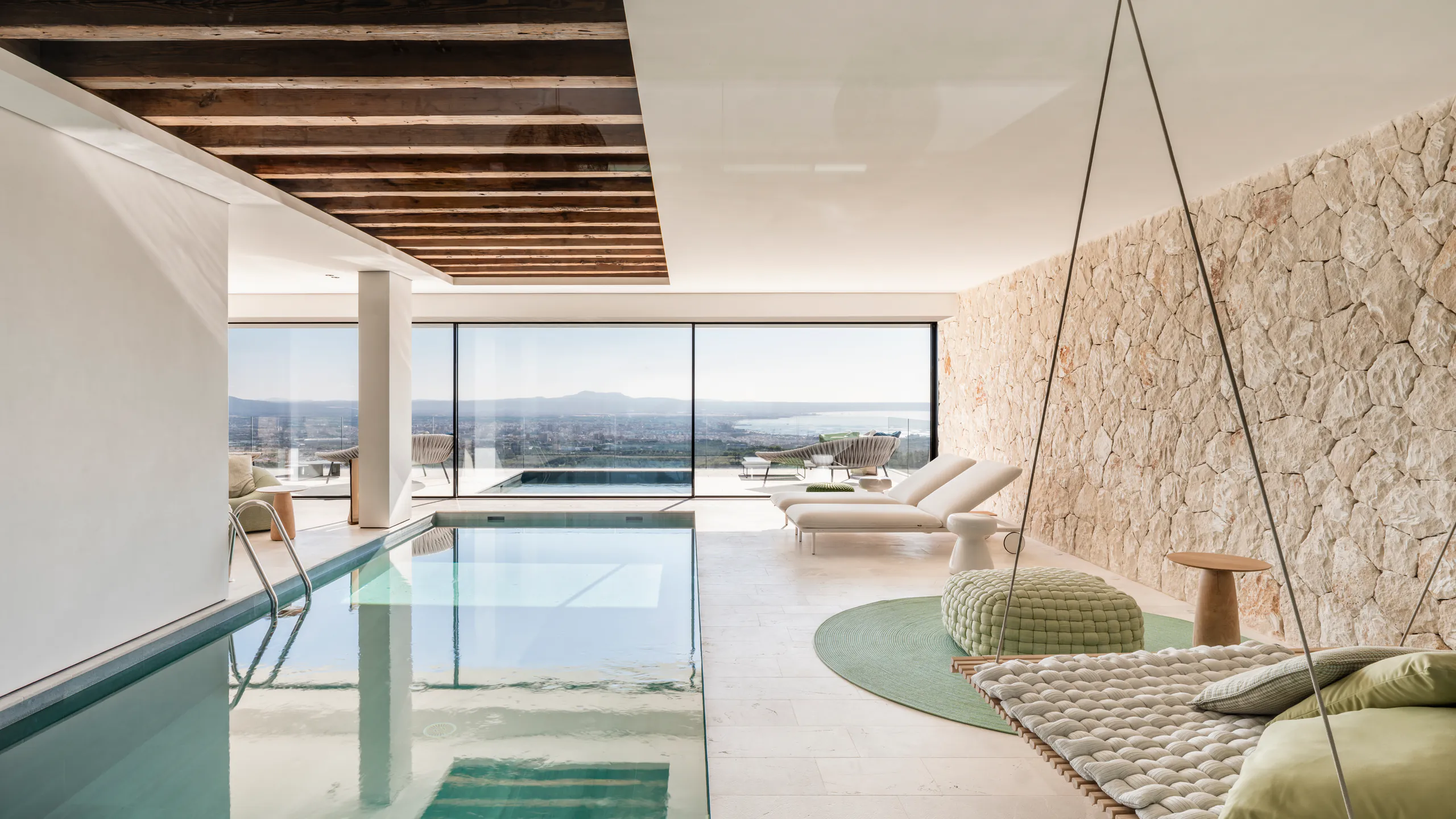 Light-filled living space opening toward a panoramic pool terrace
