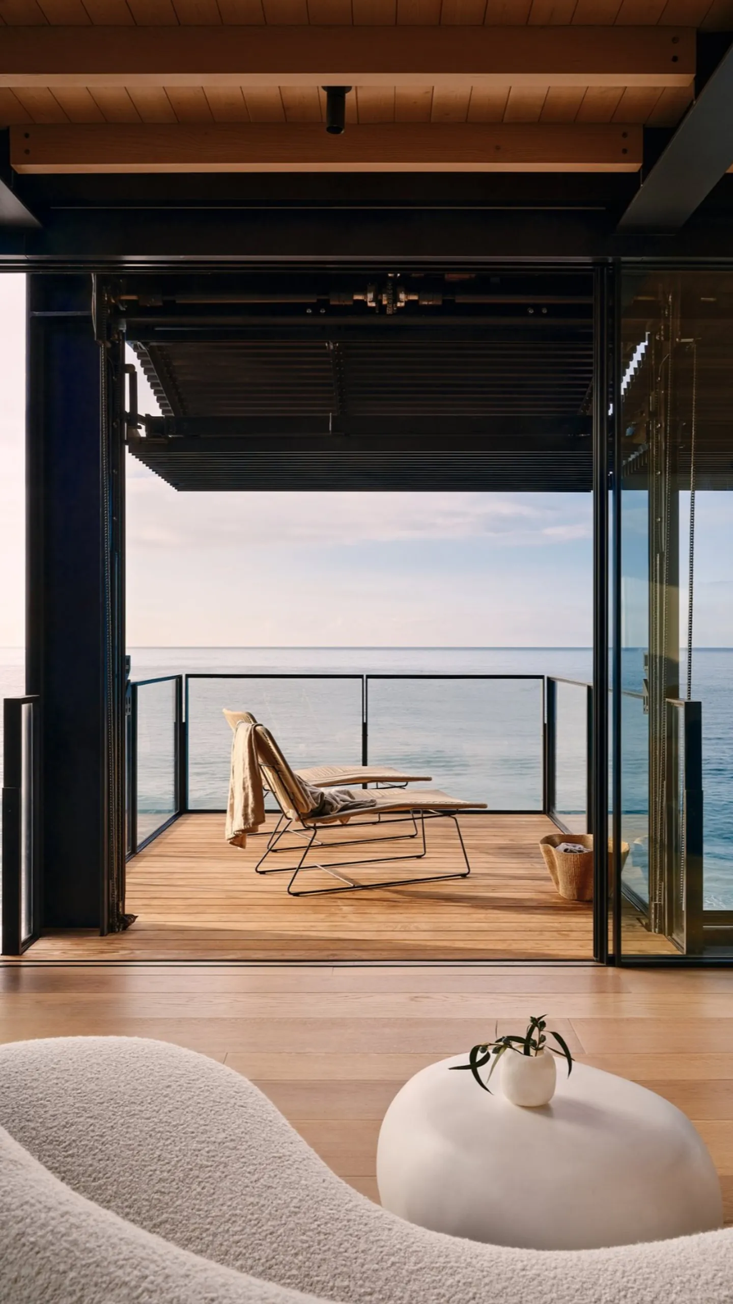 Large sliding doors opening a coastal interior to the ocean