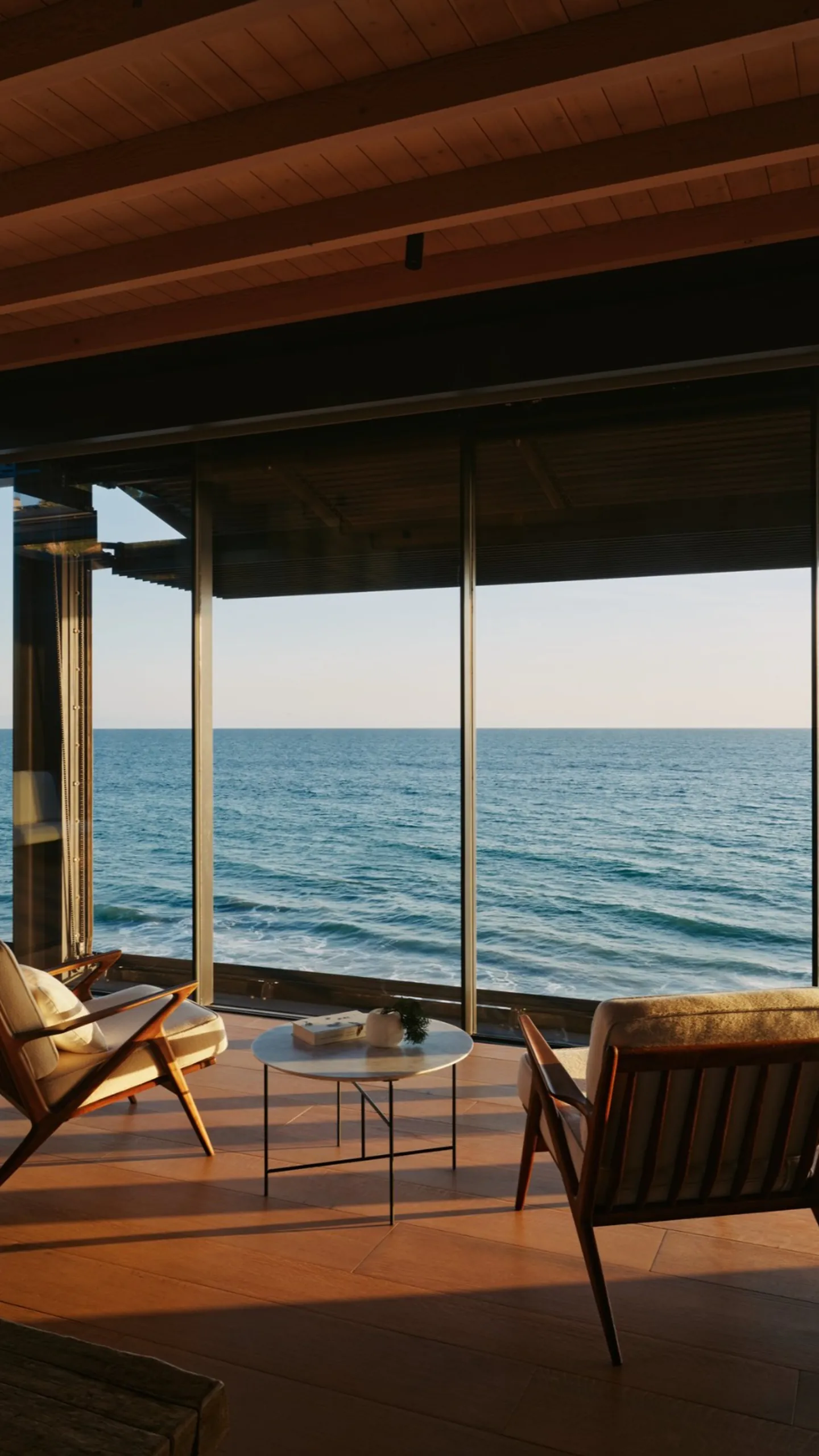 Ocean room defined by slender frames and uninterrupted views