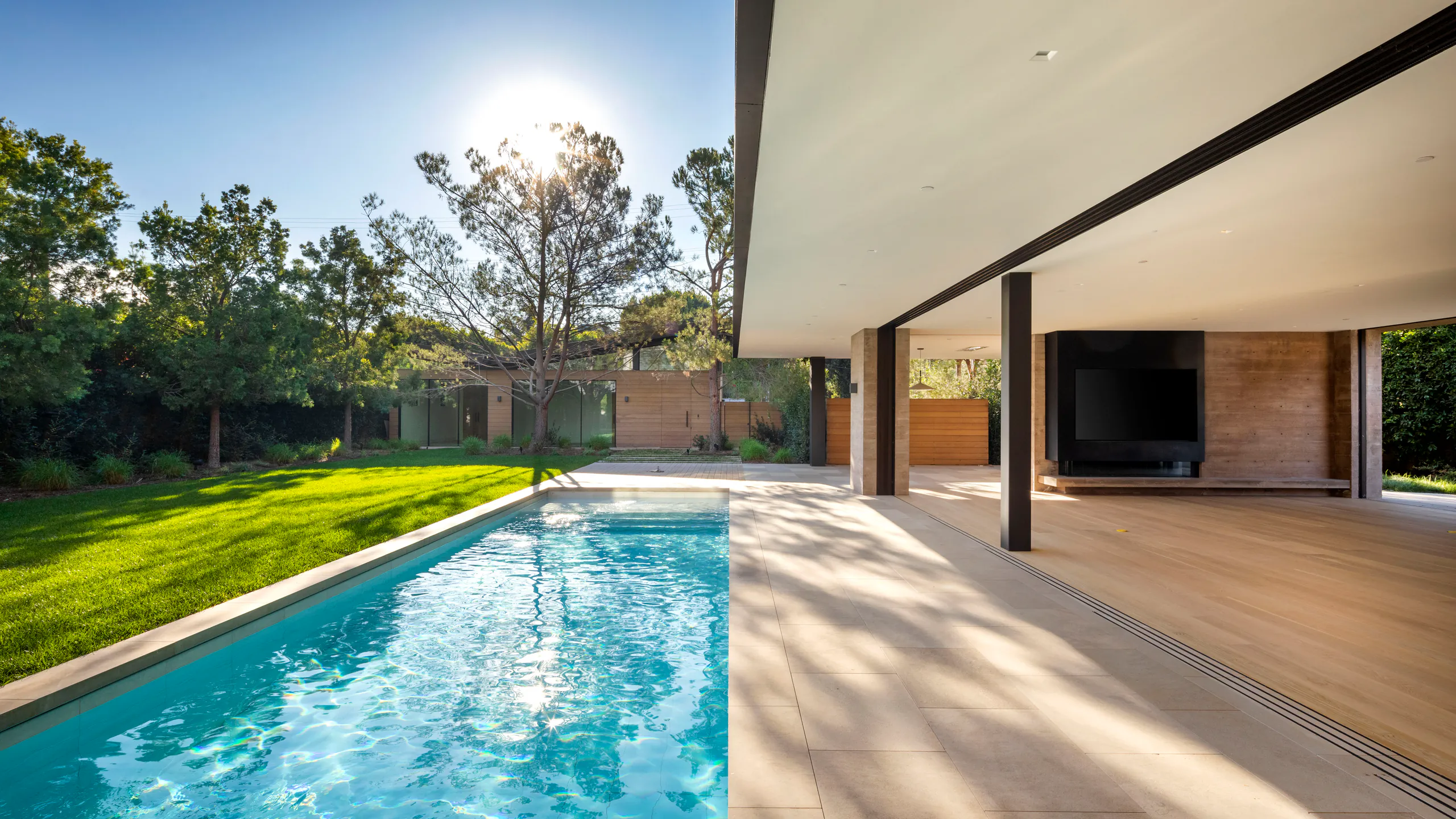 Long protected opening beside a sunlit pool