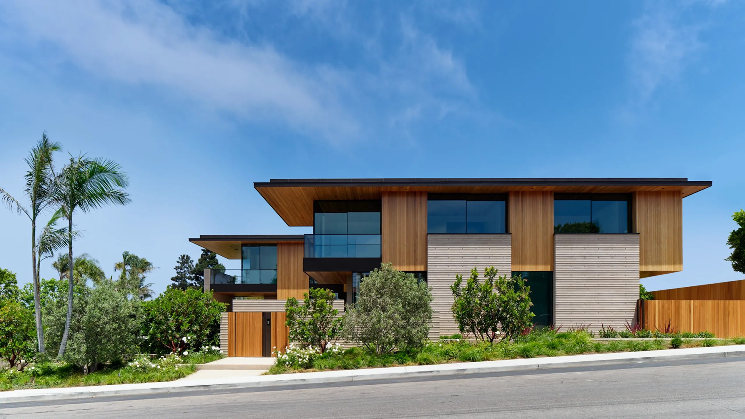 Warm-climate residence with palms and shaded glazing